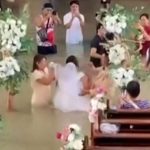 Bride walks down the aisle despite waist-deep flooding