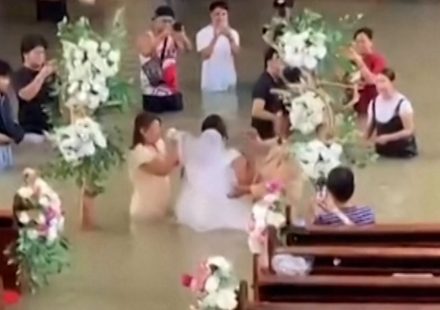 Bride walks down the aisle despite waist-deep flooding