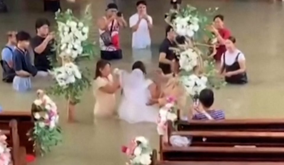 Bride walks down the aisle despite waist-deep flooding