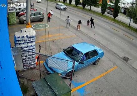 Moment shop worker dives into traffic to save child