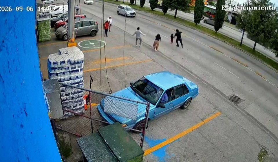 Moment shop worker dives into traffic to save child