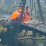 Kyiv bridge hit in further Russian drone attack as German chancellor makes surprise visit