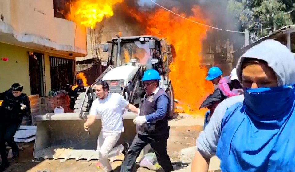 Residents douse workers with flaming gasoline during eviction in Peru